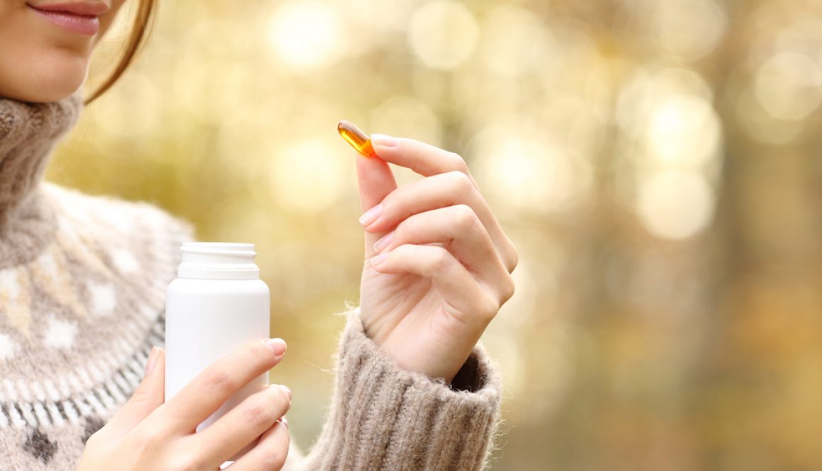 Close,Up,Of,Woman,Hand,Holding,A,Vitamin,Pill,And